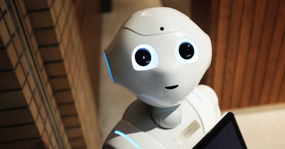 Robot hand reaching toward digital interface